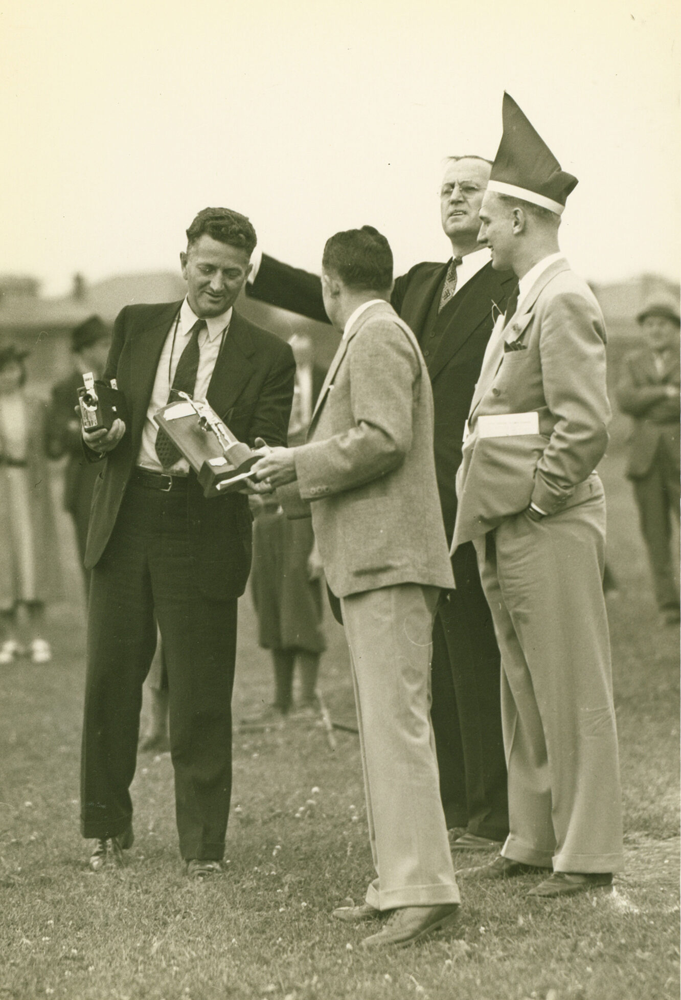 Dr. Shankweiler, holding the camera with which he filmed the 1940s footage, standing with "Haps" Benfer, Alumni Day, 1938